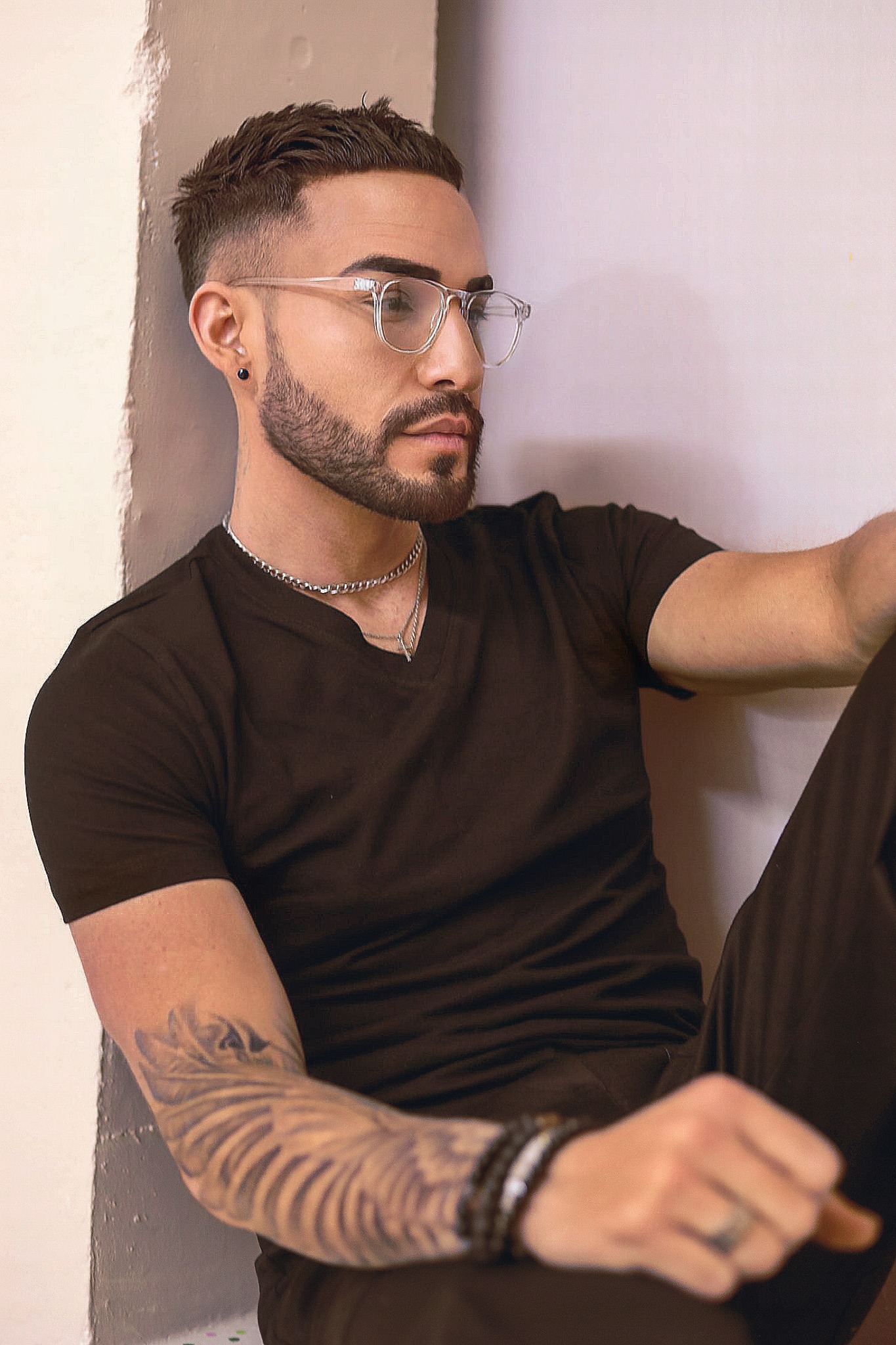 Wayne Cumming wearing clear glasses in a relaxed portrait